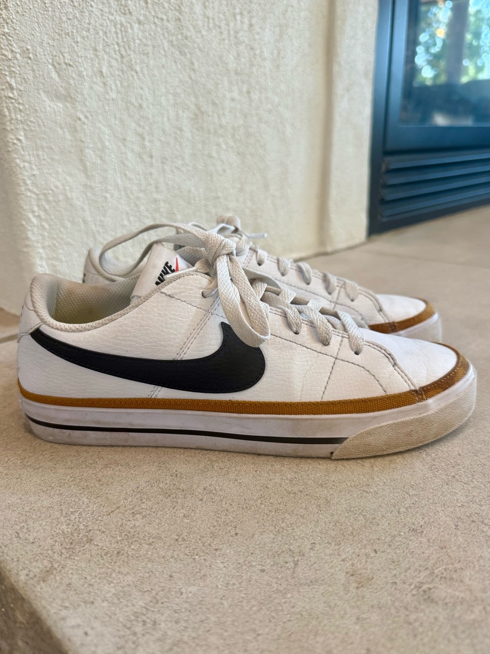 Nike White Low-Top Sneakers with Black Swoosh and Brown Trim